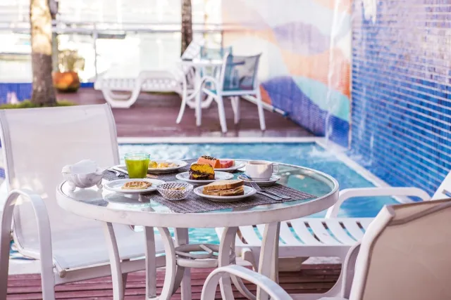Café da manhã servido ao lado da piscina do Hotel Ilhabela